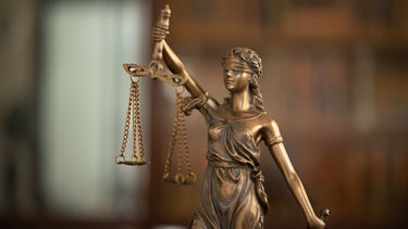 A bronze colour statue representing justice