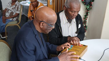 Two people using music device