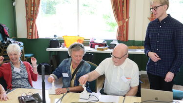 Group of people using music device