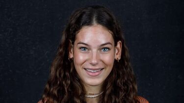frontal shot of a young woman with curly dark hair