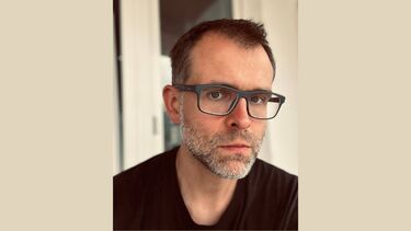 Headshot of Ivan Philippov on a beige background