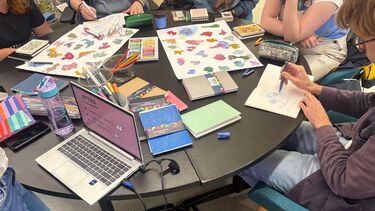 people with pens and paper 