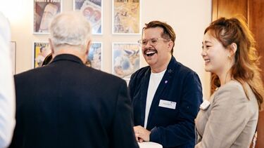 A group of alumni chatting at an alumni reception
