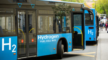 A hydrogen-powered bus turning a corner