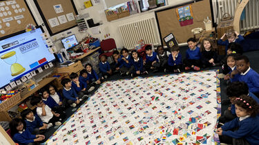 Children at Netherthorpe Primary School exploring the Quilt of Welcome