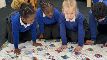 Children at Netherthorpe Primary School exploring the Quilt of Welcome