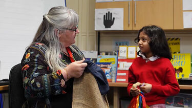 Sabine engages with a pupil in the classroom