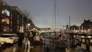2 students on a canal side ar dusk