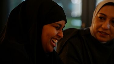 Women laughing - let's talk AI campaign