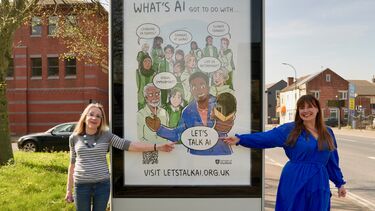 Margaret Colling and Dr Susan Oman stood in front of one of the webtoons at a bus stop