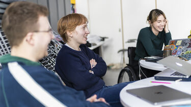 A group sitting round the table (theatre collaborators)