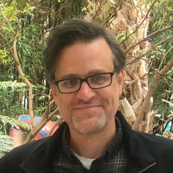 Profile picture of Headshot of man in garden