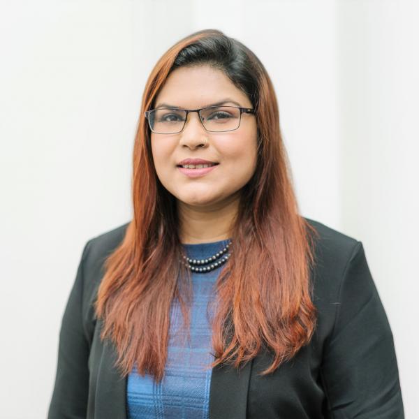 Profile picture of Sharmin Rahman wearing a blue top and black blazer.