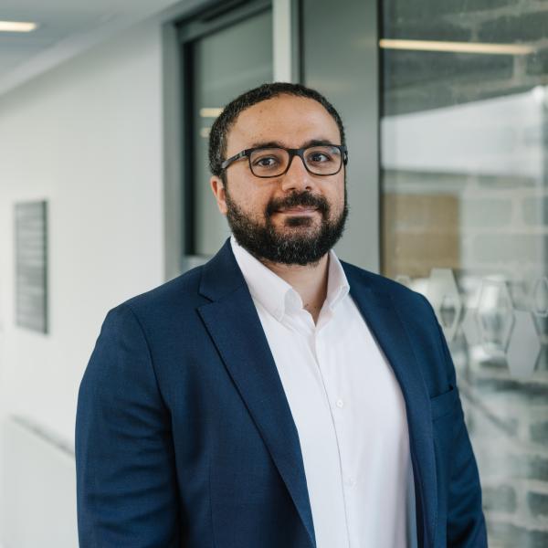 Profile picture of Mostafa Abuzeid wearing a white shirt and blue jacket.