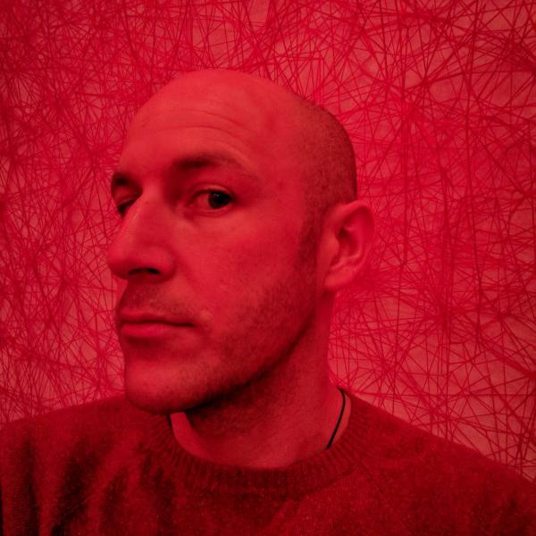 Profile picture of Photograph of Joe Morrison with a red filter over it