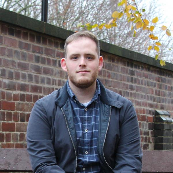 Profile picture of Harry Imlack in the law school garden with boundary wall behind her