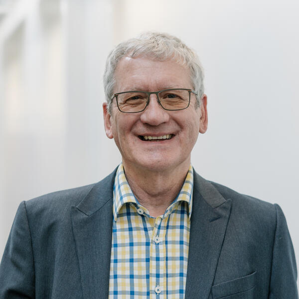 Profile picture of Richard Bruce wearing a checked shirt and a jacket.