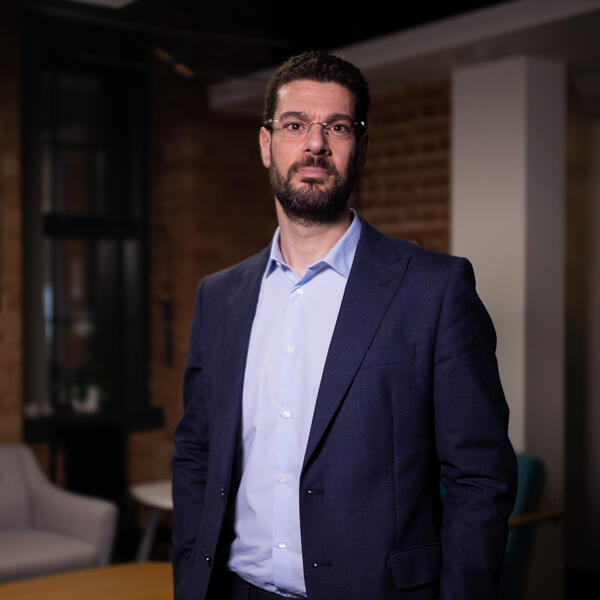 Profile picture of A photograph of George Panoutsos standing in a navy suit.