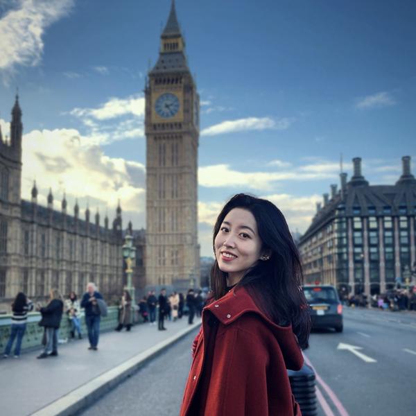 Profile picture of A photo of Xi (Helen) Chen where she is stood outside against a backdrop of the Houses of Parliament in London.