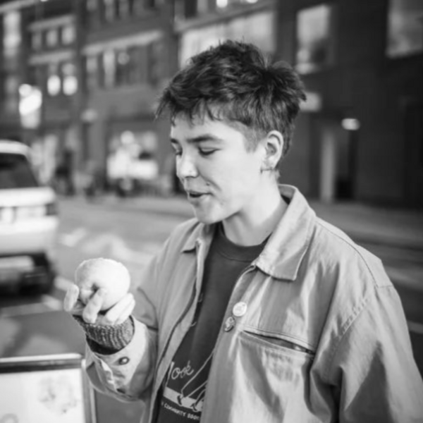 Profile picture of Black and white photograph of Emmott eating an apple