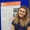 a female student standing in front of a poster presentation