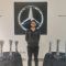 Photo of student Shamoil Khomosi at Mercedes surrounded by trophies