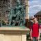 Postgraduate student Lewis beside a statue