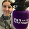 Maisie Marston smiling next to a BBC radio microphone.