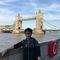 A photo of a person stood in front of Tower Bridge in London