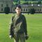 Student stood outside a country house