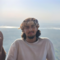 A person smiling with a landscape background