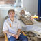 Harry, a male student nurse, sits in front of a hospital bed with an NG tube manikin.