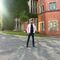 Man standing in front of red brick building on sheffield campus