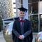Image of male student Harry baker in his graduation cap and gown