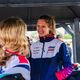 Women smiling at race track in sports gear 
