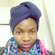 Nerea Okong'o wearing a colourful scarf and blue headwrap.