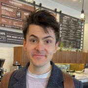 Mathew smiling in a campus cafe