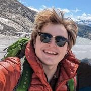 Luke Richardson in sunglasses on a mountain