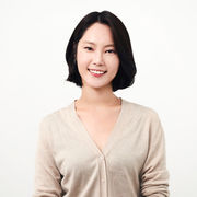 Academic Kahee Jo sat smiling in beige coloured blouse