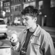 Black and white photograph of Emmott eating an apple