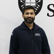 Man with brown hair and a beard in AMRC uniform