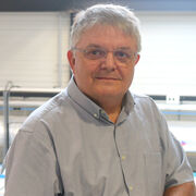 Man with glasses in a pale blue shirt