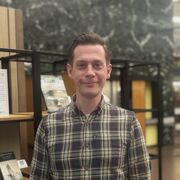 Oliver stands in the catalogue hall in Western Bank Library 