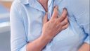 A person clutching their chest, suffering from a heart attack
