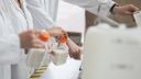 Scientists handling powder in bottles