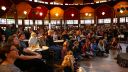 A crowd of people sat inside a Spiegeltent watching a performance at a previous Festival of the Mind