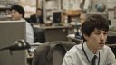 Korean worker sat in office at computer