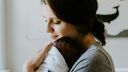 A woman cradling a young baby