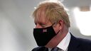 Boris Johnson in a black mask embroidered with a union jack flag. 