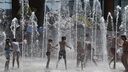 Children playing in an outdoor water fountain